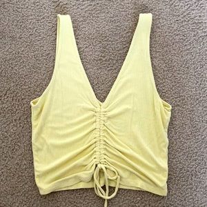 adjustable length crop top with strings and ruffles in the front.